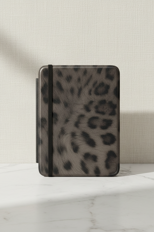 Leopard print case on a marble surface with a neutral background